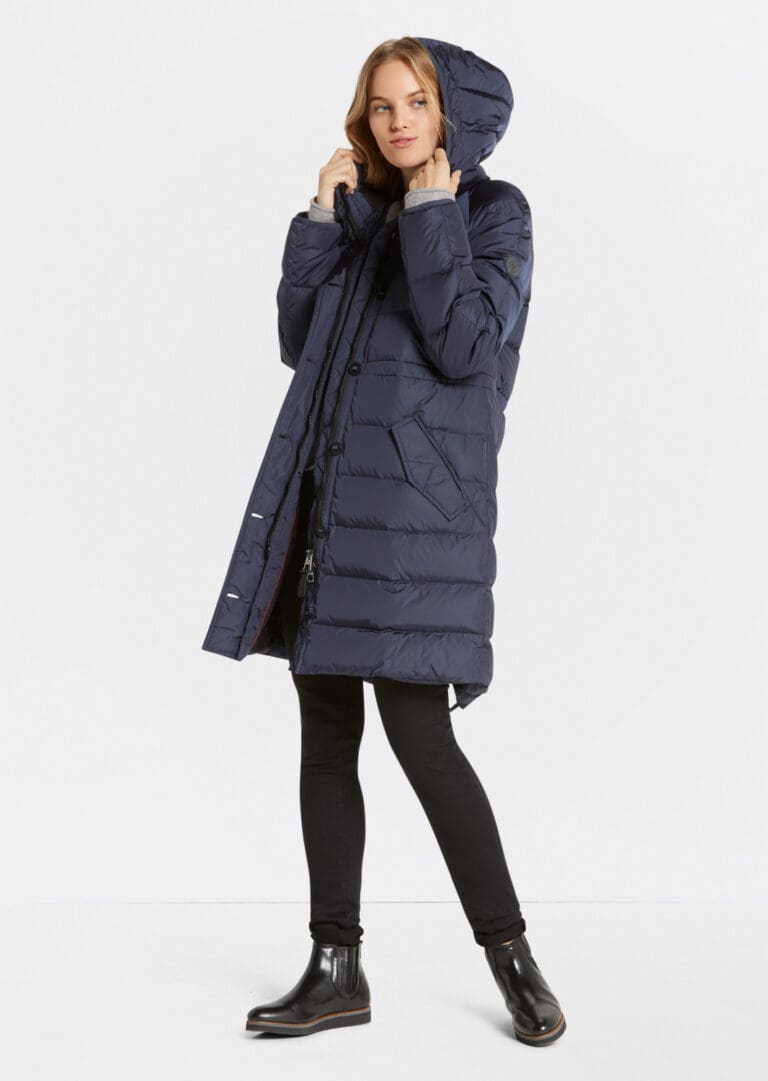 Woman modeling long navy blue winter coat