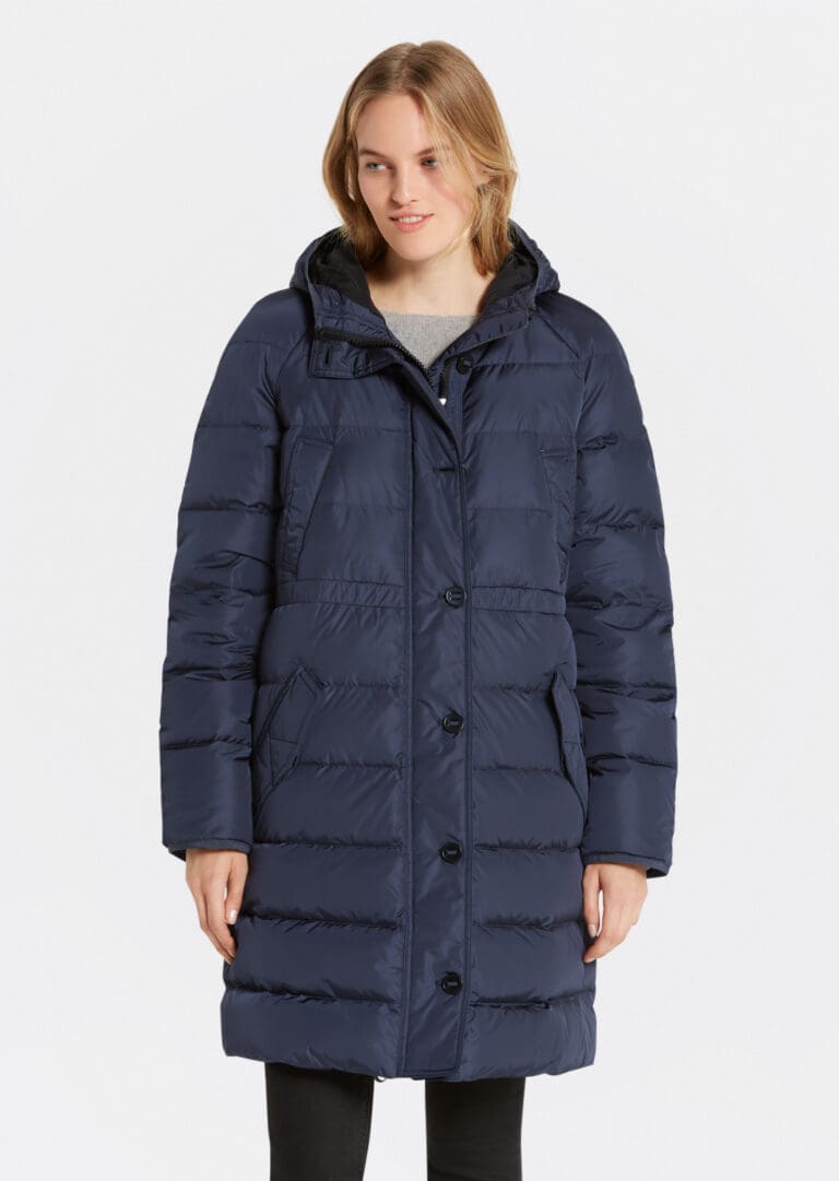 Woman wearing long navy blue puffer coat