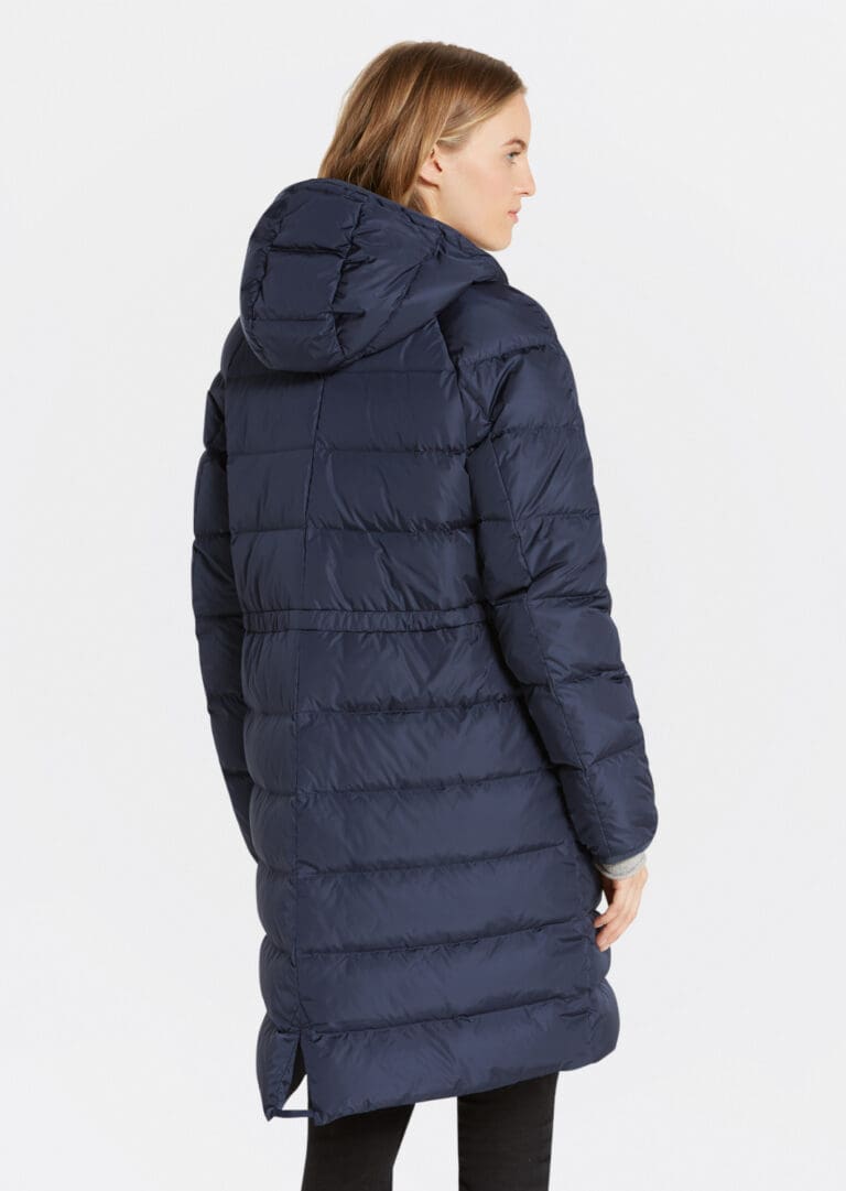 Woman wearing long navy blue puffer coat