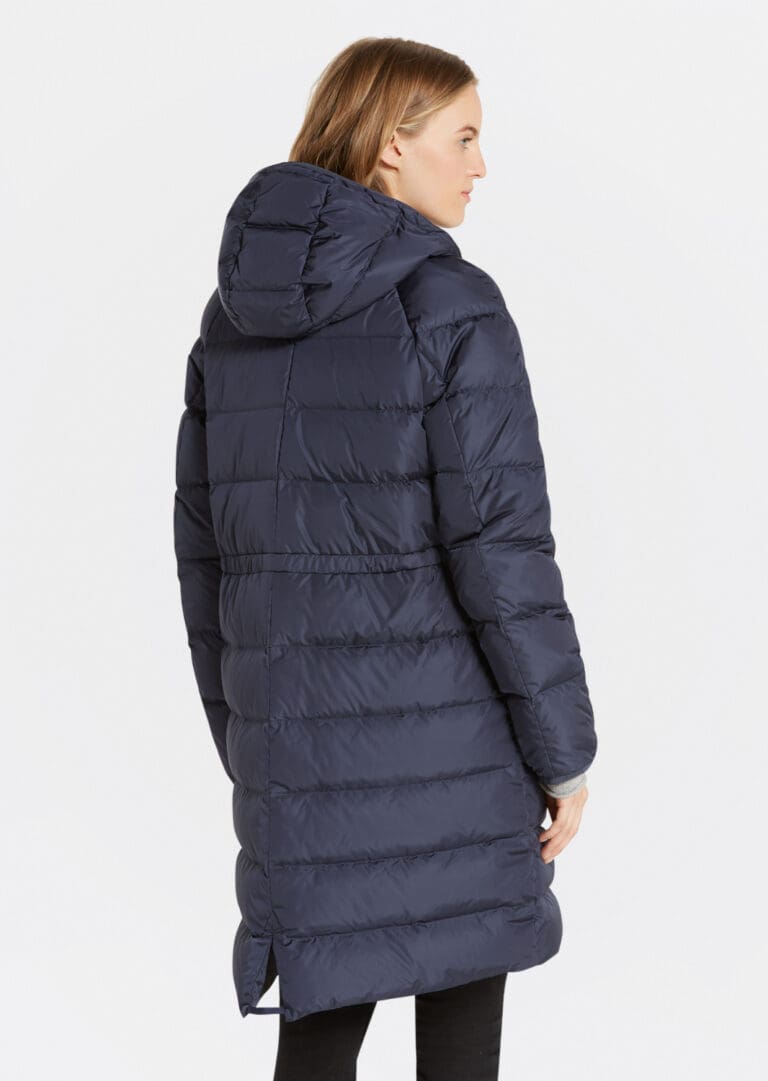 Woman wearing long navy puffer coat