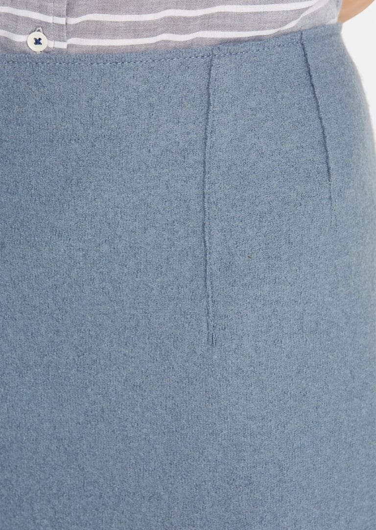 Close-up of blue fabric skirt with front seam detail