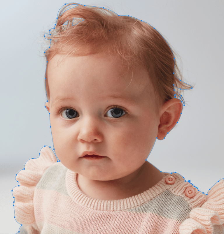 Toddler with blue eyes wearing pastel sweater