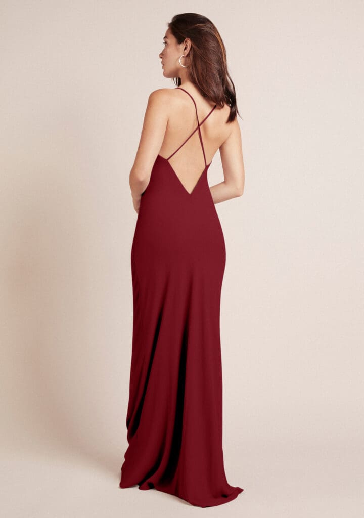 Woman in elegant red backless dress