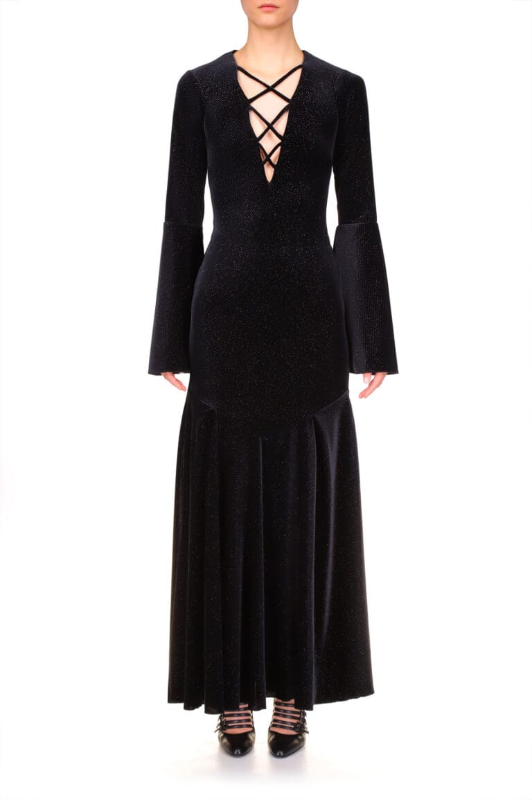 Woman in elegant black long-sleeve dress with lace-up neckline