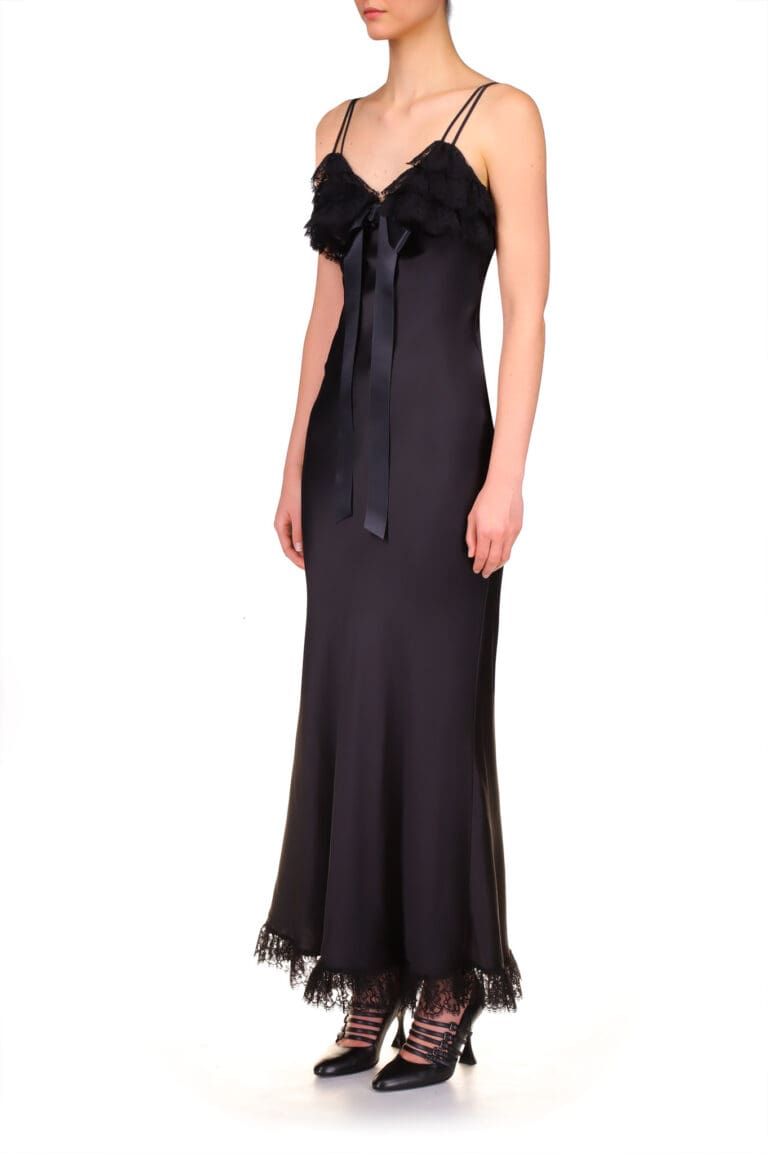 Woman in elegant black silk dress with lace details