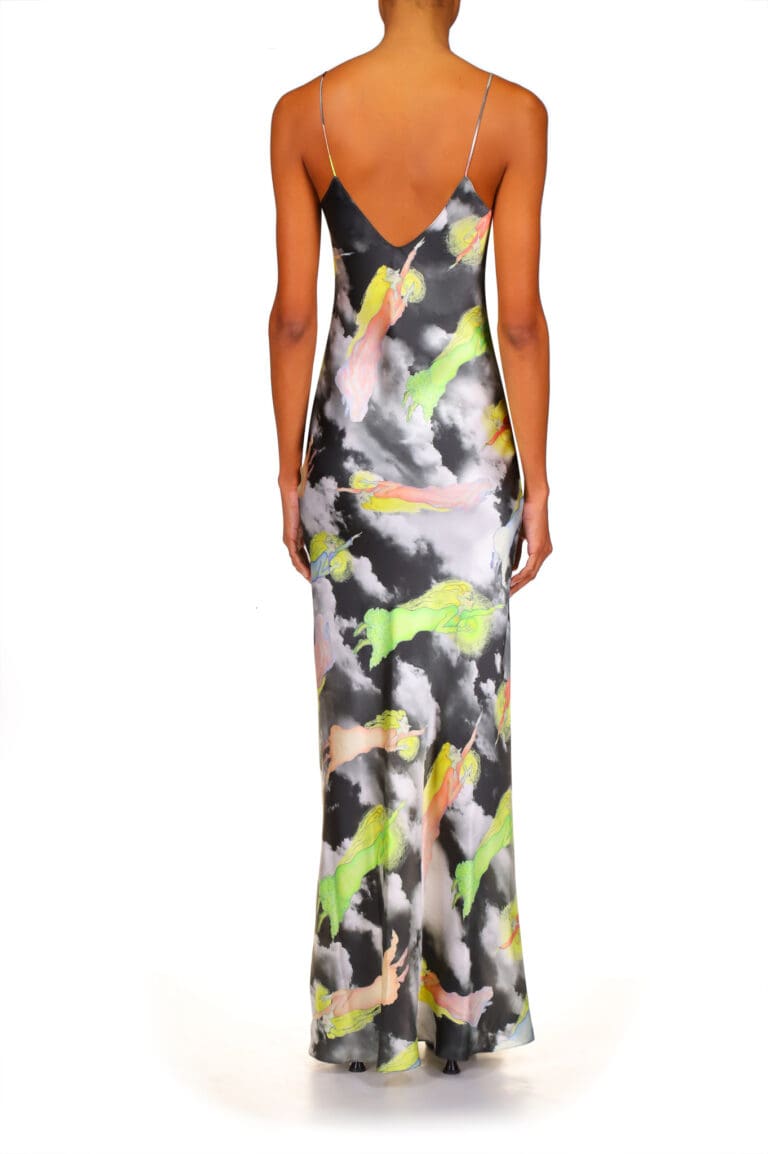 Woman in colorful floral maxi dress standing back