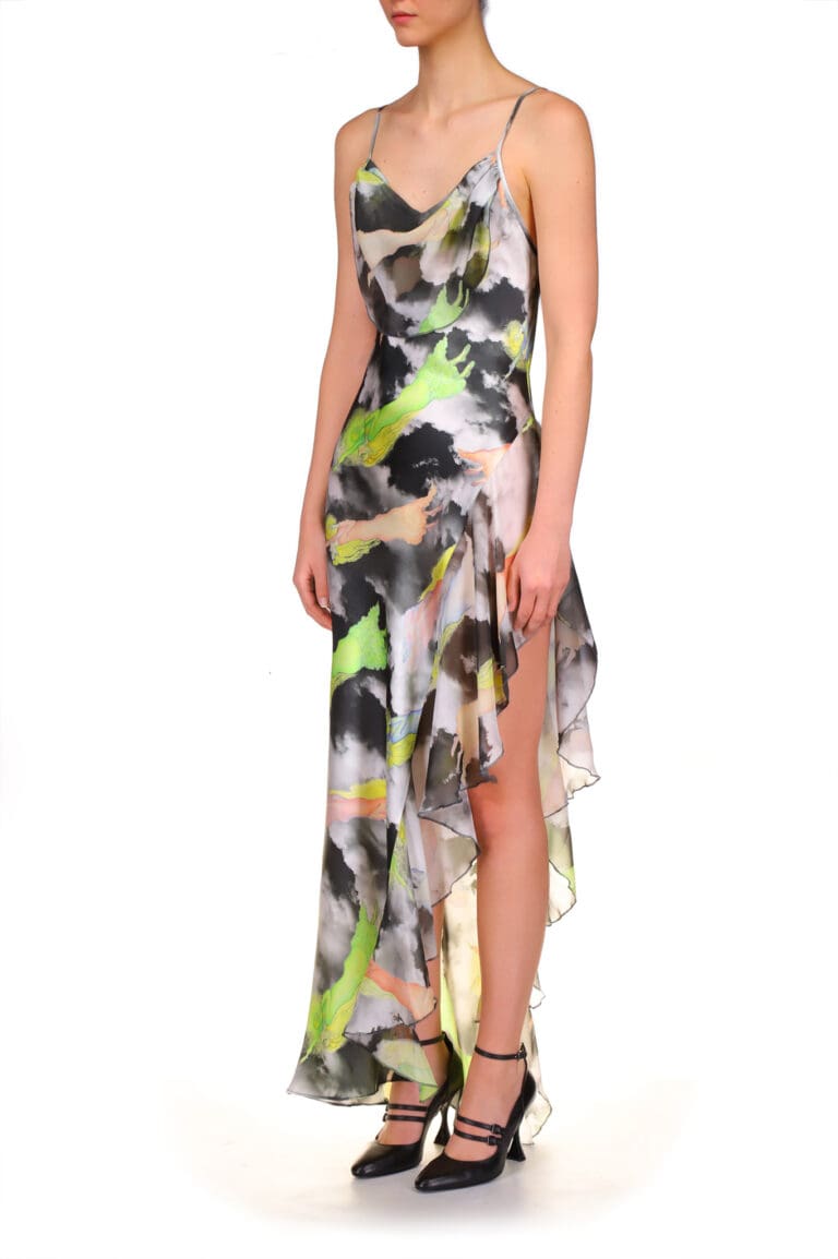 Woman in flowing multicolored abstract print dress