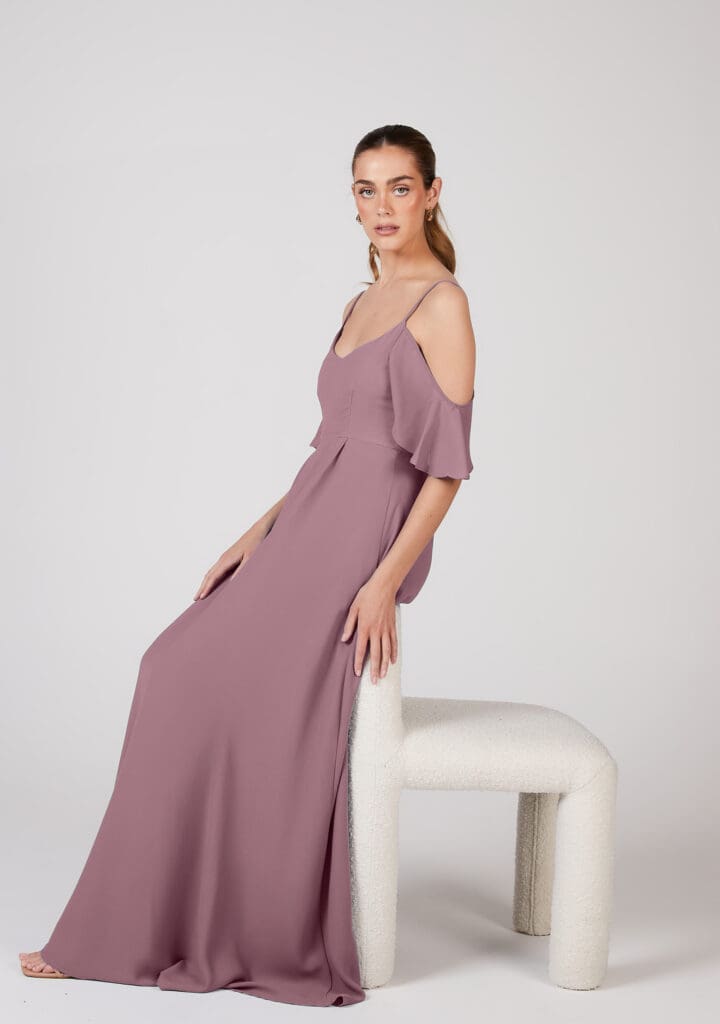 Woman posing in elegant mauve off-shoulder gown